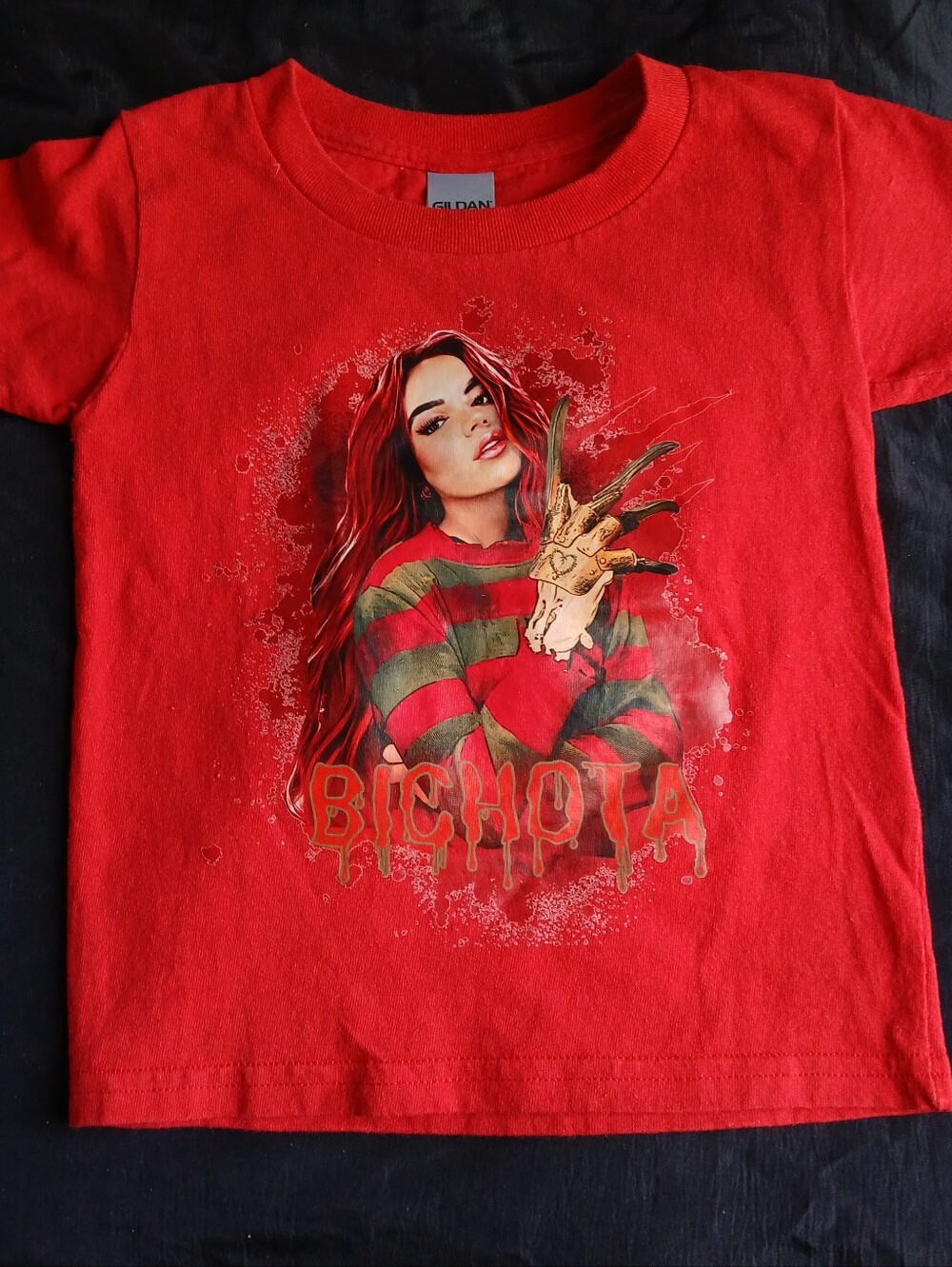 Red Bichota kids graphic tee with graphic of Karol G as Freddy Krueger